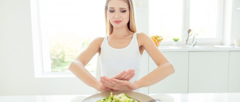 Woman putting her salad away - fear of gaining weight